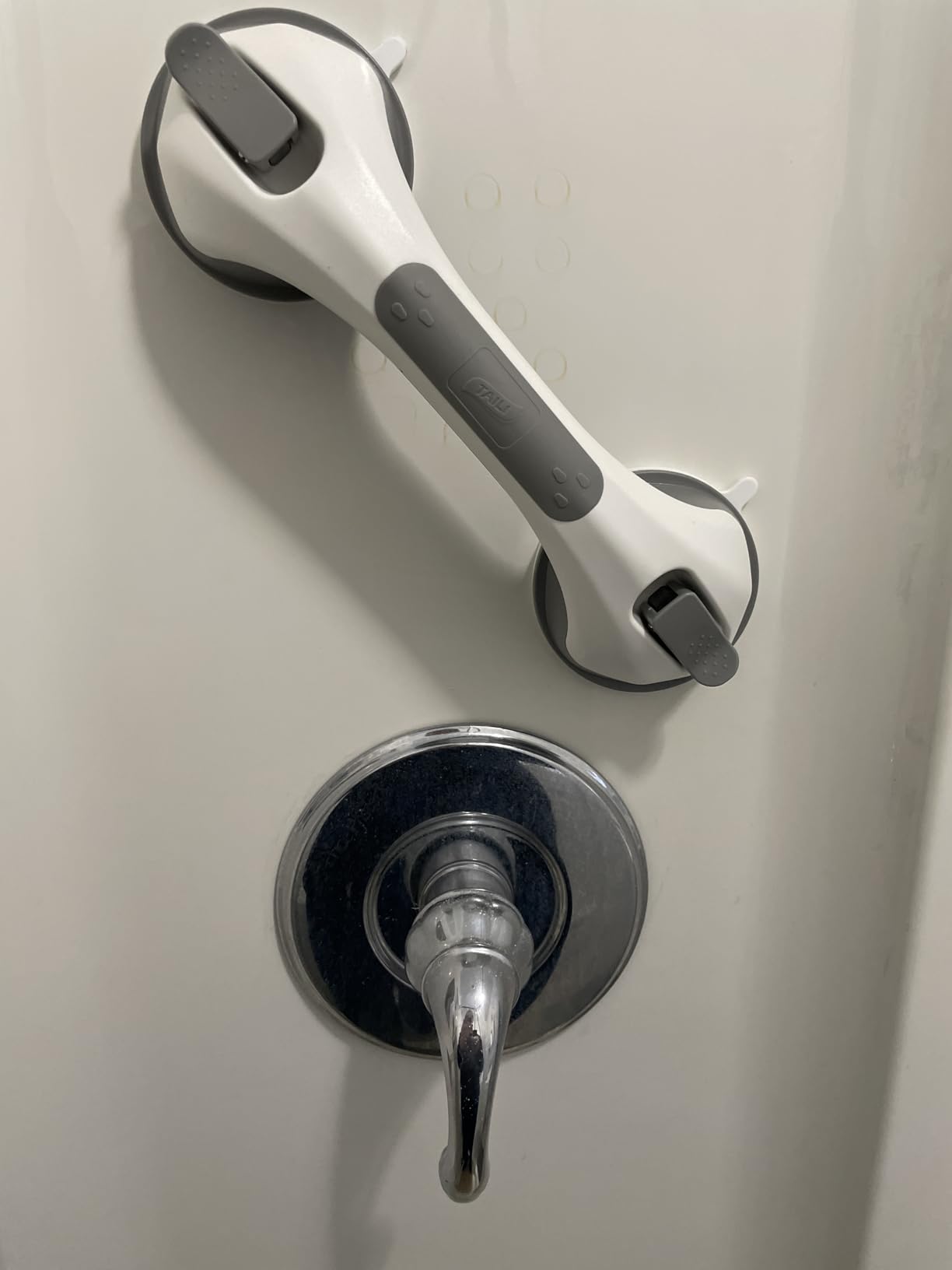 Grab bar installed beside bathtub faucet